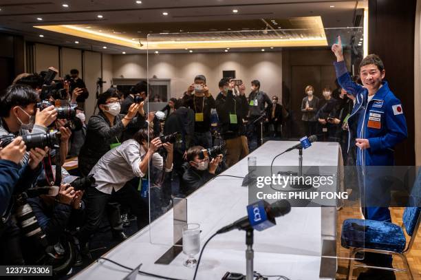 Japanese billionaire Yusaku Maezawa, who went to the International Space Station last month as a "space tourist", gestures in front of the media as...