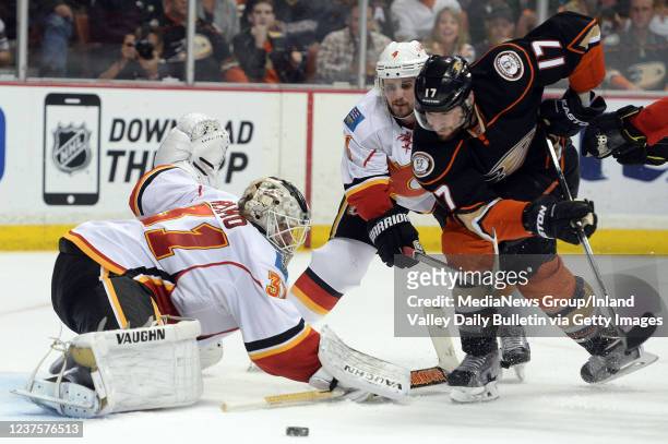 The Ducks Ryan Kesler battles for a loose puck in front of the net with Calgary goalie Karri Ramo and Kris Russell during the second period Sunday...