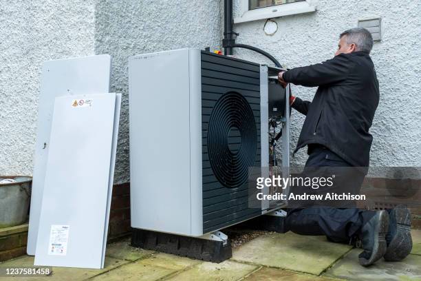 An air source heat pump repairman from Valiant replaces a Wilo pump inside a Vaillant Arotherm plus 7kw air source heat pump unit at a house in...