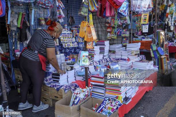 Person sells school supplies at a street market on January 1, 2022 in San Salvador, El Salvador. Salvadoran families return to shops and premises in...
