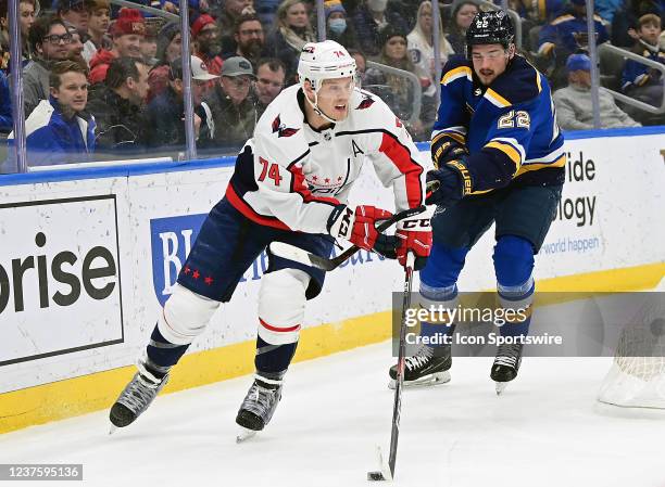 Washington Capitals defenseman John Carlson controls the puck with pressure fromSt. Louis Blues center Logan Brown during a NHL game between the...