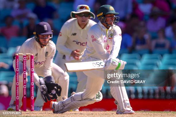 Australia's Usman Khawaja hits a reverse sweep shot on day four of the fourth Ashes cricket test between Australia and England at the Sydney Cricket...