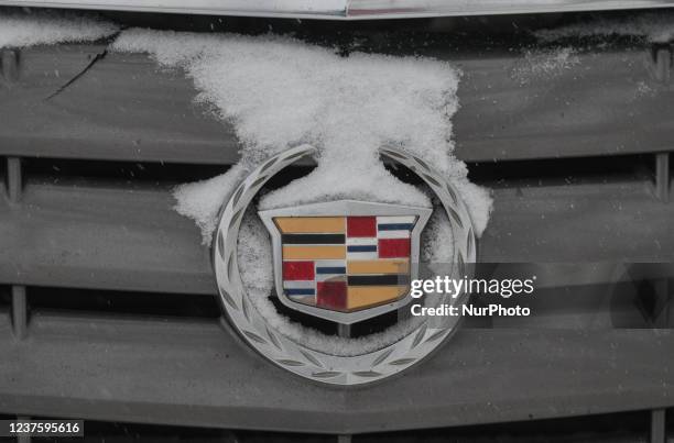 Cadillac logo seen on a Cadillac car partially covered with snow in downtown Edmonton. On Friday, January 7 in Edmonton, Alberta, Canada.