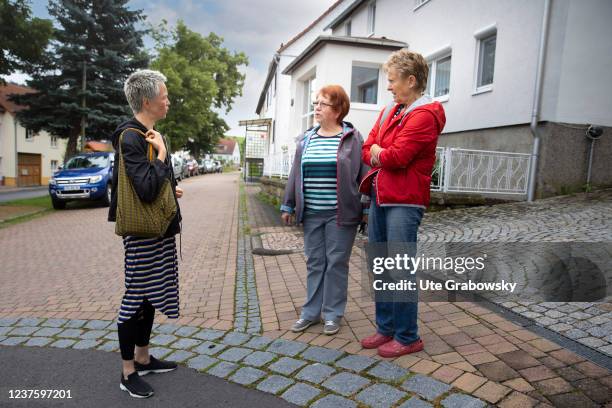 In this photo illustration Neighborhood, Women talking to each other on July 07, 2021 in Buecheloh, Germany.