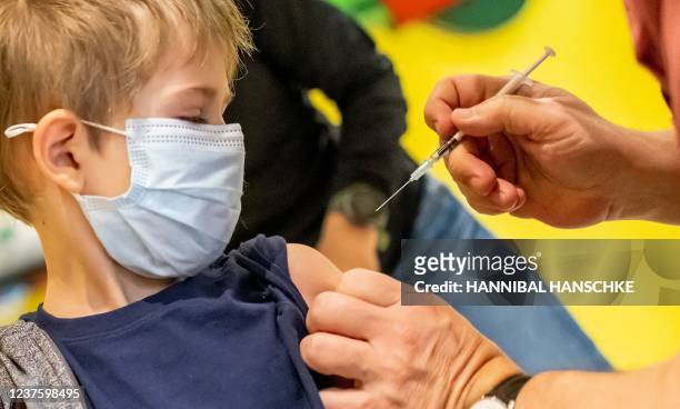 Doctor inoculates 5-year-old Phillip with the first dose of the Pfizer-BioNTech vaccine against the coronavirus during a vaccination action against...