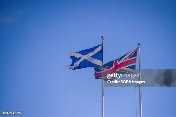 The national flag of Scotland and the Union Jack flag are seen at Horse Guards Parade.