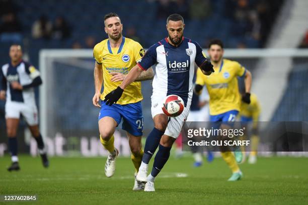 West Bromwich Albion's English-born Scottish midfielder Matt Phillips runs after the ball as Brighton's Irish defender Shane Duffy chases after him...