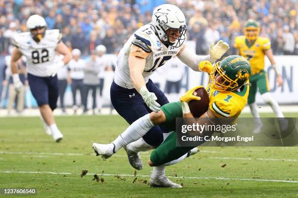 Christian Watson of the North Dakota State Bison is tackled by Troy Andersen of the Montana State Bobcats during the Division I FCS Football...