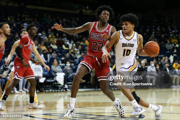 Toledo Rockets guard RayJ Dennis drives to the basket against Northern Illinois Huskies guard Edward Manuel during the first half of a regular season...