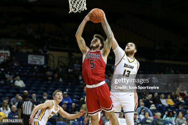 Northern Illinois Huskies forward Chris Osten puts back a rebound against Toledo Rockets center Mihai Carcoana during the second half of a regular...