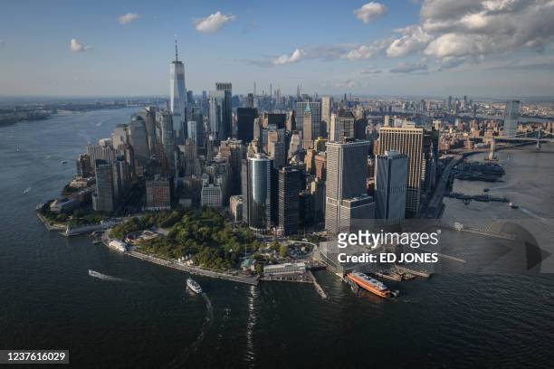 An aerial general view shows the lower Manhattan skyline and New York city on August 6, 2021. - Superstorm Sandy in 2012 was the trigger for...