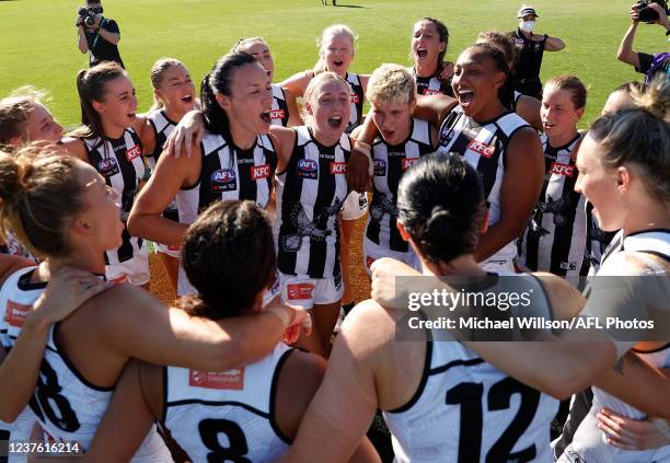Alison Downie, Eliza James, Eloise Chaston and Sabrina Frederick of the Magpies sing the team song during the 2022 AFLW Round 01 match between the...