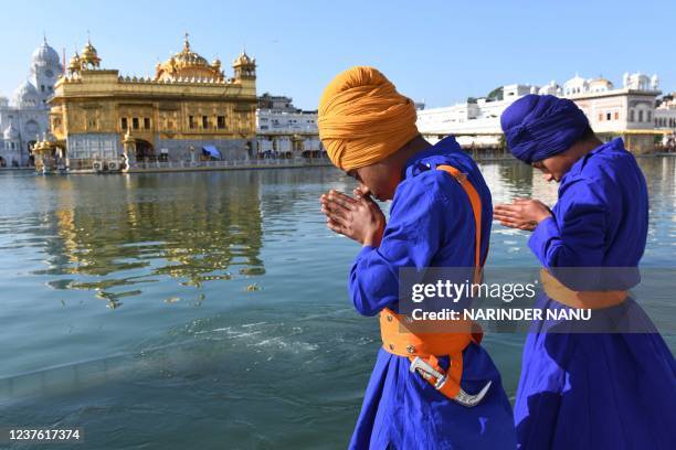 Sikh devotees pay respect on the occasion of the birth anniversary of the 10th Sikh Guru Gobind Singh at the Golden Temple in Amritsar on January 9,...