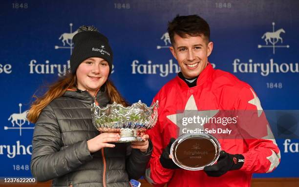 Meath , Ireland - 9 January 2022; Jodie Foley, daughter of winning owner representative Joe Foley, and jockey Bryan Cooper with their trophies after...