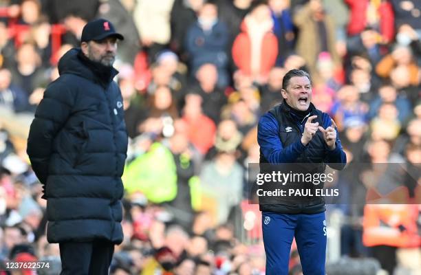 Liverpool's German manager Jurgen Klopp and Shrewsbury Town's English manager Steve Cotterill react during the English FA Cup third round football...