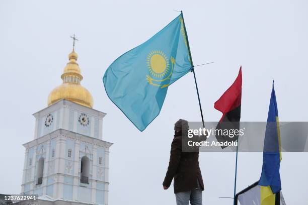 Man holds a flag of Kazakhstan during a rally "Say no to Putin" in Kiev, Ukraine on January 9, 2021. Ukrainian nationalists are displeased with the...