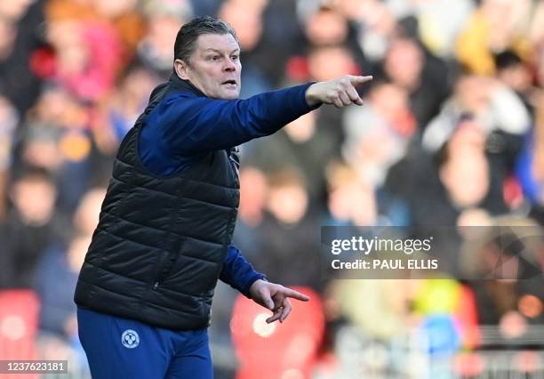 Shrewsbury Town's English manager Steve Cotterill shouts instructions to his players from the touchline during the English FA Cup third round...