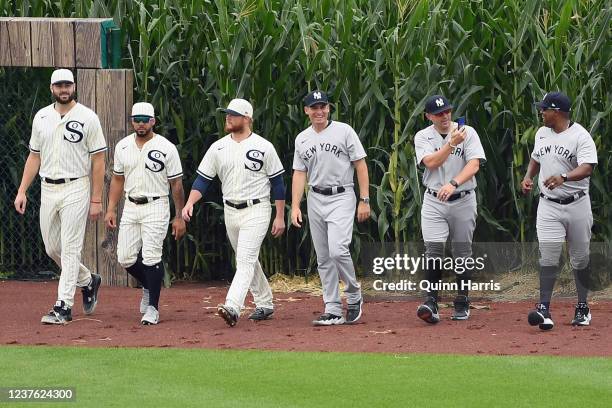 Members of the New York Yankees and the Chicago White Sox enter the field before the game at MLB Field at Field of Dreams on Thursday, August 12,...