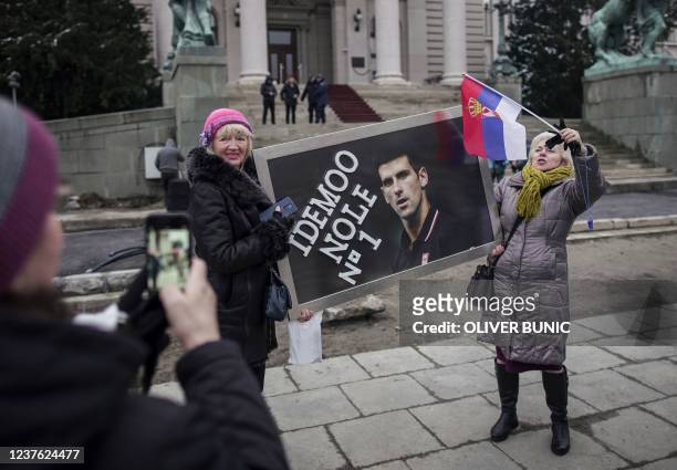 Supporters hold a banner reading "Let's go Nole " with a picture of Serbian tennis player Novak Djokovic, during a rally in front of Serbia's...
