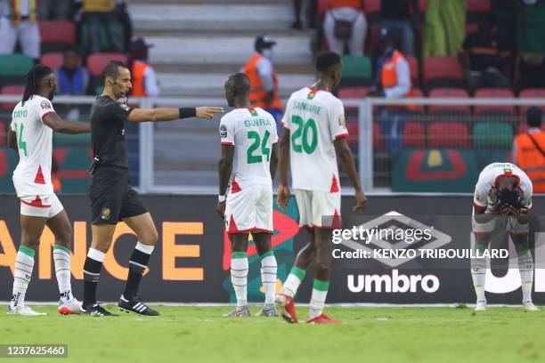 Burkina Faso's defender Issa Kabore reacts as Algerian referee Mustapha Ghorbal gives a penalty against Burkina Faso during the Group A Africa Cup of...