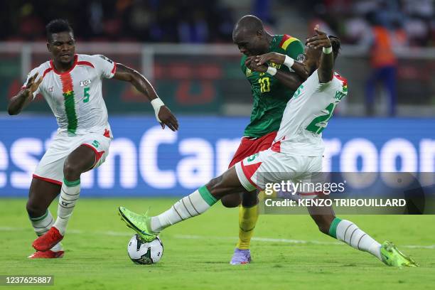 Cameroon's forward Vincent Aboubakar is tackled by Burkina Faso's defender Steeve Yago during the Group A Africa Cup of Nations 2021 football match...