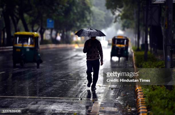 Commuters out on a cold and rainy morning at Lodi Road, on January 9, 2022 in New Delhi, India.