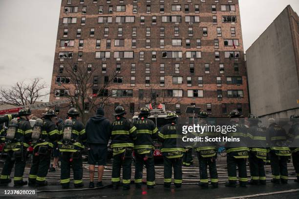 Emergency first responders remain at the scene after an intense fire at a 19-story residential building that erupted in the morning on January 9,...