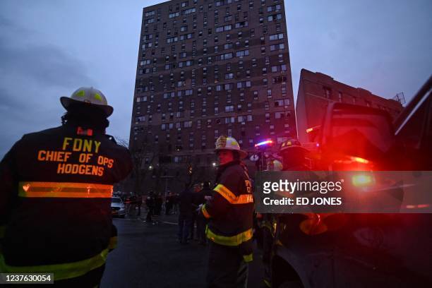 Firefighters work outside an apartment building after a deadly fire in the Bronx, on January 9 in New York. - At least 19 people have died and dozens...