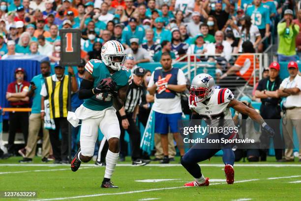 Miami Dolphins wide receiver DeVante Parker runs with the ball after a catch during the game between the New England Patriots and the Miami Dolphins...