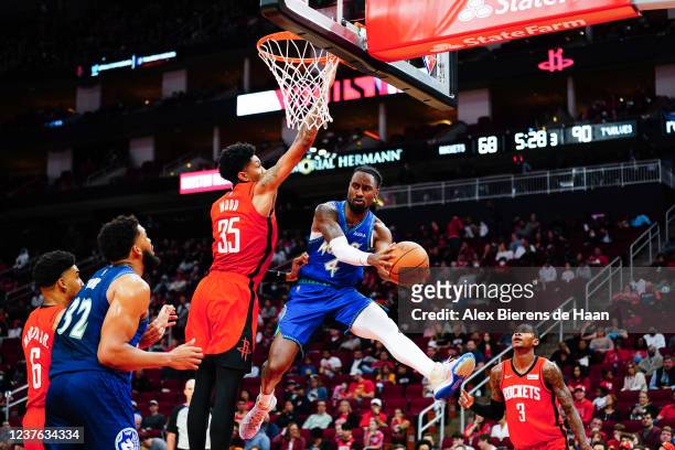 Jaylen Nowell of the Minnesota Timberwolves passes around Christian Wood of the Houston Rockets during the game at Toyota Center on January 9, 2022...