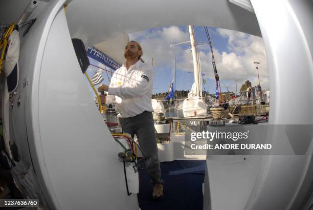 French skipper Yvon Noblet winches sails on his monohull 4O pieds Appart City, in Saint-Malo, 24 October 2006. Noblet will participate to the solo...