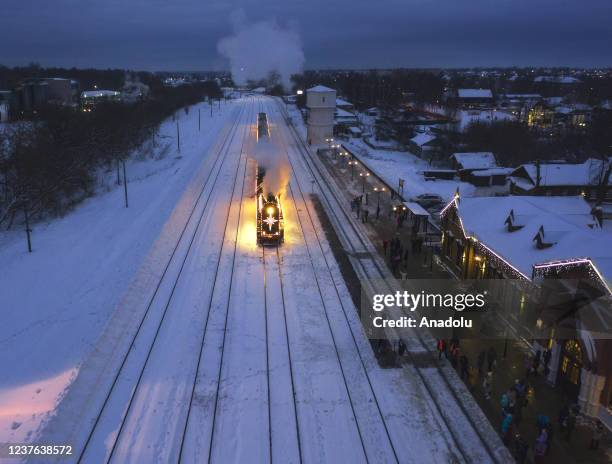 The Christmas retro train passing through the picturesque forests of the Ivanovo region arrives at the station in Shuya town of Ivanovo Oblast,...