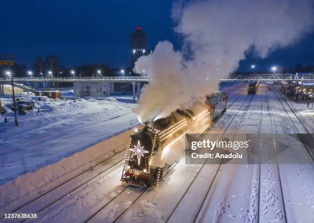 The Christmas retro train passing through the picturesque forests of the Ivanovo region arrives at the station in Shuya town of Ivanovo Oblast,...