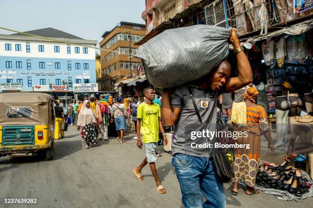 Resident carries a sack through Idumota market in Lagos, Nigeria, on Thursday, Jan. 6, 2022. Nigerias Lagos state government plans to build new...