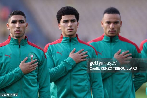 Morocco's defender Achraf Hakimi and teammates listen to the national anthem ahead of the Africa Cup of Nations 2021 football match between Morrocco...