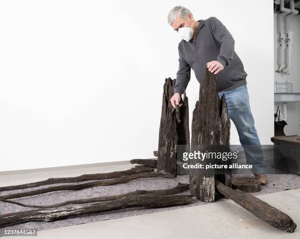 January 2021, Baden-Wuerttemberg, Kleinheppach: Parts of a wooden wine press from the 14th century that are lying to dry in a room of the Stone Age...