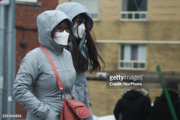 People wearing face masks to protect themselves from the novel coronavirus while walking along Yonge Street in Toronto, Ontario, Canada on January...