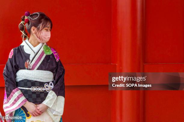 Young woman in traditional kimono visits Senso-ji temple to celebrate Seijin no Hi . Japanese people who have their 20th birthday in this year...