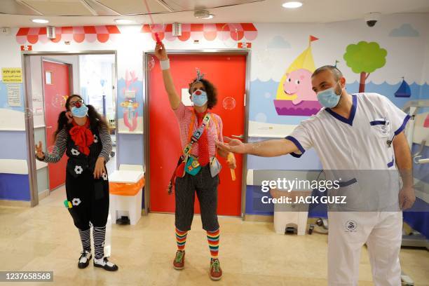 Medical clowns blow bubbles for the reopening of the dedicated children's coronavirus disease ward which reopened as a response to increased...