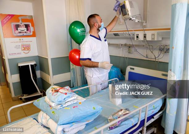 Member of the medical staff of the Sheba Medical Centre prepares a room of the dedicated children's coronavirus disease ward which reopened as a...