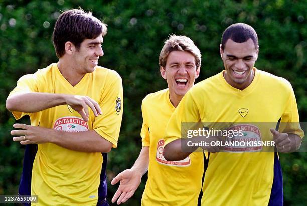 Juninho Pernambucano , Juninho Paulista and Denilson of the Brazilian national soccer team joke as they exercise during a training session in Cali,...