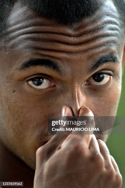 Brazilian forward Ewerthon holds his nose, 22 July 2001 at a training session in Cali, Colombia. Brazil is set to face Honduras 23 July in Manizales,...