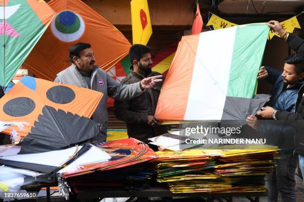 People buy kites ahead of Lohri, the spring festival, at a shop in Amritsar on January 11, 2022.