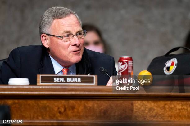 Sen. Richard Burr offers Sen. Tim Kaine an orange, Dr. Pepper and a blanket during a Senate Health, Education, Labor, and Pensions Committee hearing...