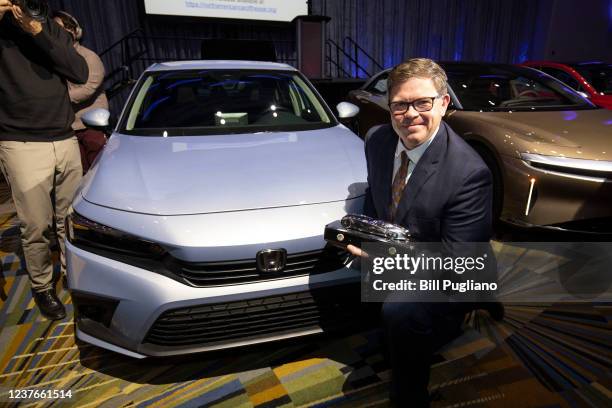 Matt Almond, Honda Zone Manager North Central Zone, holds the award for the 2022 Honda Civic winning the 2022 Car of the Year Award at the 2022 North...