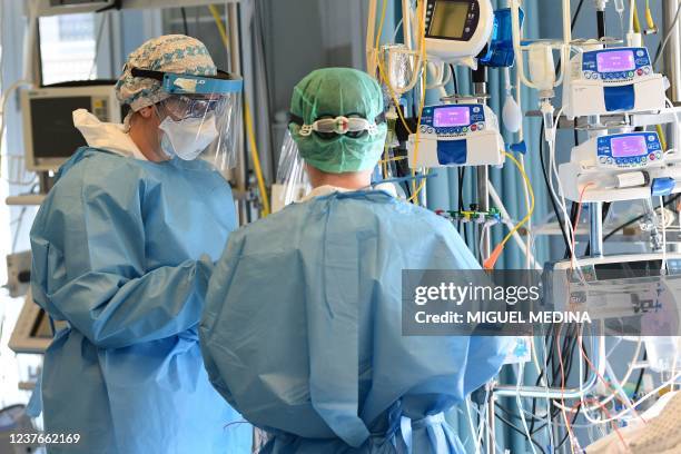 Medical staff members stand in a Covid-19 patient room in the intensive care unit of Cremona hospital, in Cremona, northern Italy, on January 11,...