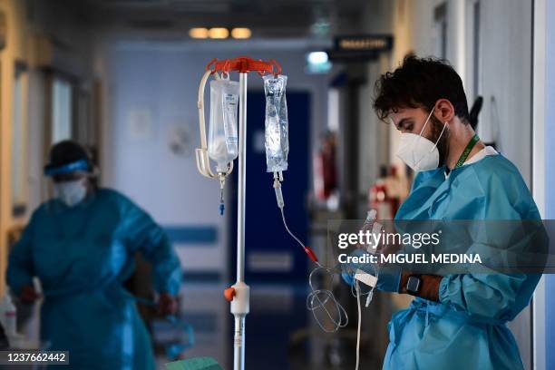 Member of the medical staff wearing a personal protective equipment stands in a corridor of the Covid-19 intensive care unit of Cremona hospital, in...