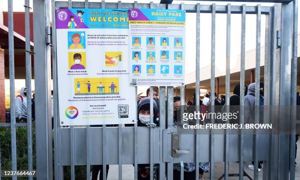 Safe and healthy protocols for Covid-19 are posted on a gate as students return to Olive Vista Middle School on the first day back following the...