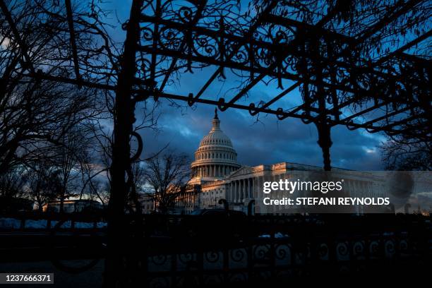 The US Capitol is seen at sunset in Washington, DC on January 11, 2022.