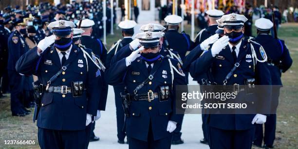 The Baltimore Police Department Honor Guard renders a salute during the funeral services for Baltimore Police Officer Keona Holley onJanuary 11, 2022...